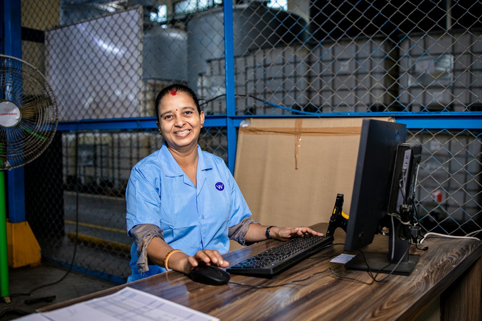 Illustrative warehouse team reviewing parcel records